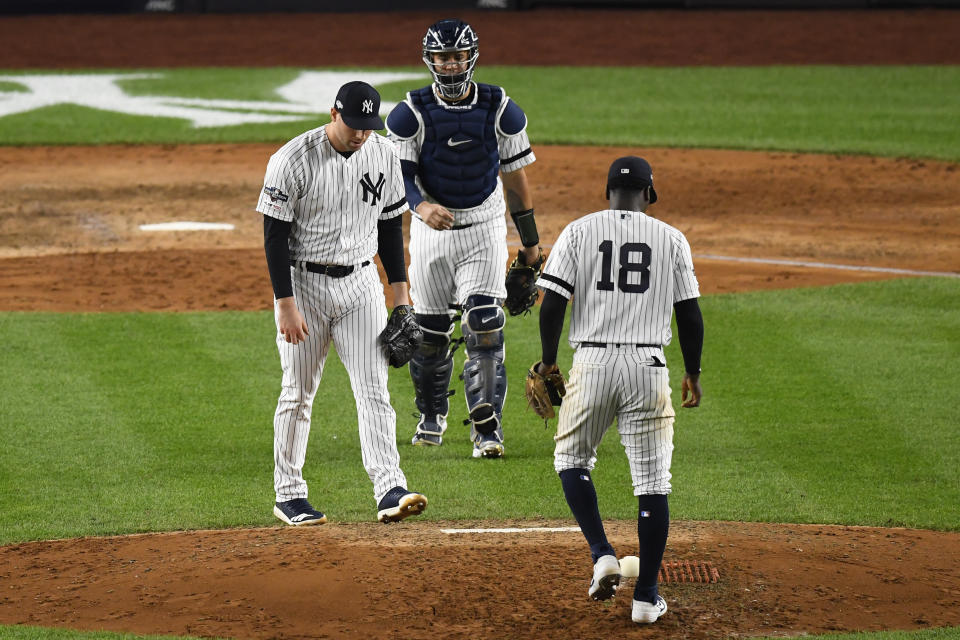 Oct 15, 2019; Bronx, NY, USA; (Editors Notes: Caption Correction) New York Yankees relief pitcher Adam Ottavino (0) reacts after giving up a single to Houston Astros second baseman Jose Altuve (not pictured) as shortstop Didi Gregorius (18) and catcher Gary Sanchez (24) look on during the seventh inning of game three of the 2019 ALCS playoff baseball series at Yankee Stadium. Mandatory Credit: Robert Deutsch-USA TODAY Sports