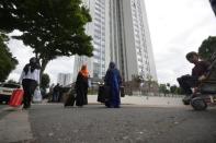 Residents are evacuated from the Burnham Tower residential block as a precautionary measure following concerns over the type of cladding used on the outside of the building on the Chalcots Estate in north London, Britain, June 24, 2017. REUTERS/Hannah McKay