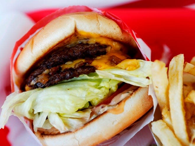 In-N-Out Burger's signature Double-Double Burger and French Fries arranged for a photograph at the In-N-Out Burger restaurant in Costa Mesa, California, U.S., on on Wednesday, February 6, 2013. Photographer: Patrick Fallon/Bloomberg