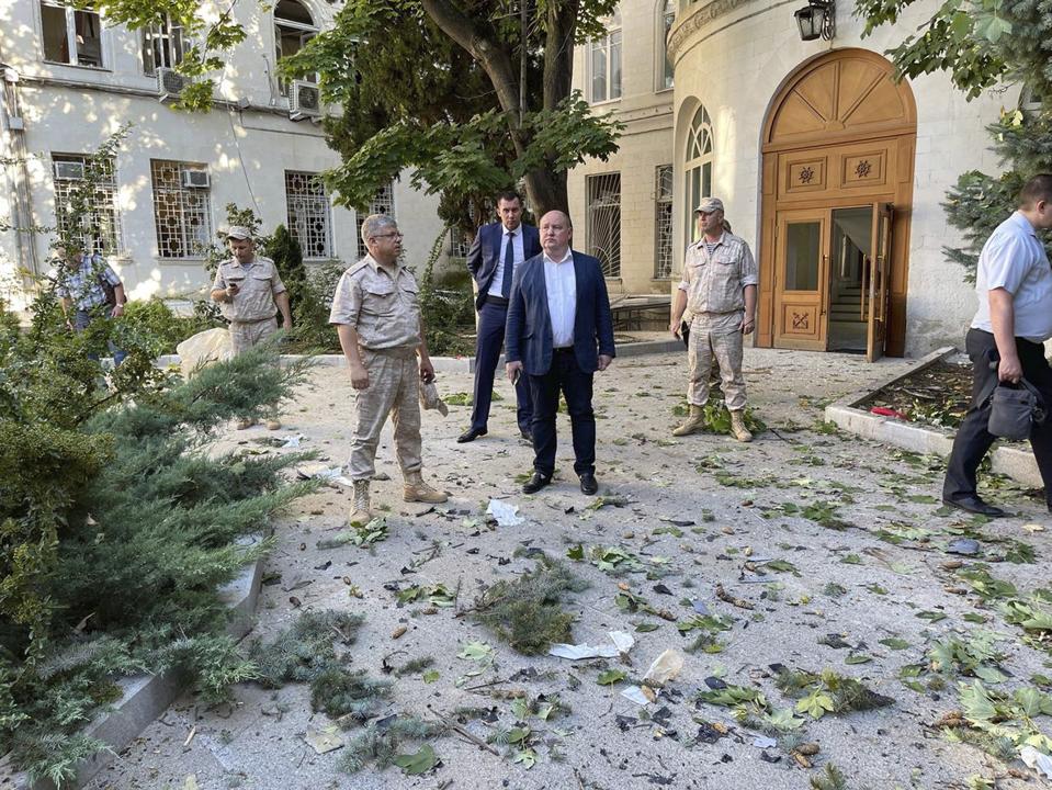 FILE - In this photo released by Sevastopol mayor Mikhail Razvozhaev telegram channel on July 31, 2022, Governor of Sevastopol Mikhail Vladimirovich Razvozhayev, center, stands at the scene of explosion at the headquarters of Russia's Black Sea Fleet in Sevastopol, Crimea. Russia's Black Sea Fleet has suffered heavy damage from Ukrainian drone and missile attacks. (Sevastopol mayor Mikhail Razvozhaev telegram channel via AP/File)