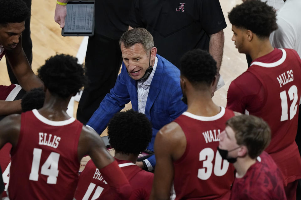Alabama head coach Nate Oates speaks to his players during a time out during the first half of an NCAA college basketball game in Starkville, Miss., Saturday, Feb. 27, 2021. (AP Photo/Rogelio V. Solis)