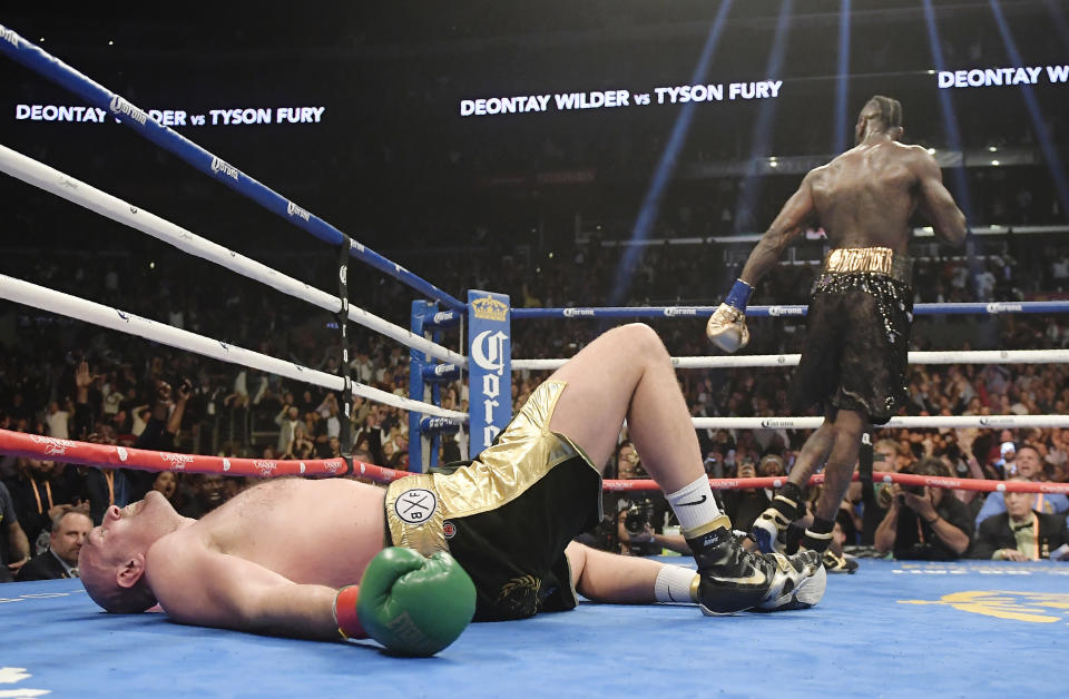 Tyson Fury lies on the canvas after being knocked down by Deontay Wilder during the 12th round of their WBC heavyweight championship boxing match in L.A. The bout ended in a draw. (AP Photo/Mark J. Terrill, File)