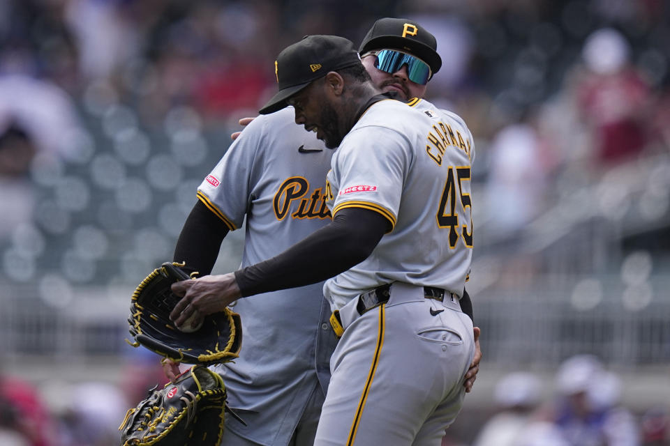 Pittsburgh Pirates pitcher Aroldis Chapman (45) celebrates a win with Pittsburgh Pirates' Rowdy Tellez (44) against the Atlanta Braves, after a baseball game, Sunday, June 30, 2024, in Atlanta. (AP Photo/Brynn Anderson)