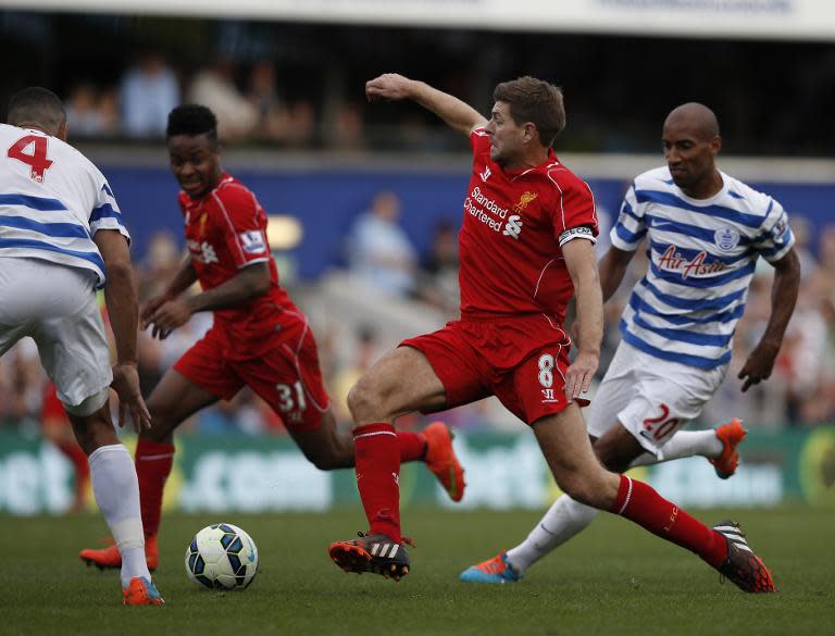 Liverpool's Steven Gerrard (2nd R) looks to pass the ball during an English Premier League match against Queens Park Rangers at Loftus Road in London on October 19, 2014