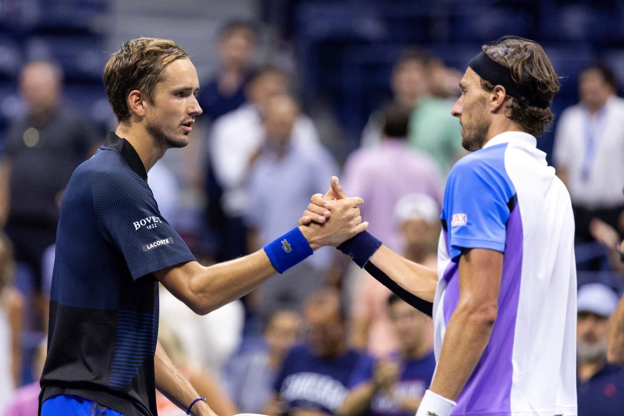 Russia's Daniil Medvedev (L) greets France's Arthur Rinderknech (R) at the net after winning following their 2022 U.S. Open Tennis tournament men's singles second round match at the USTA Billie Jean King National Tennis Center in New York on Aug. 31, 2022.