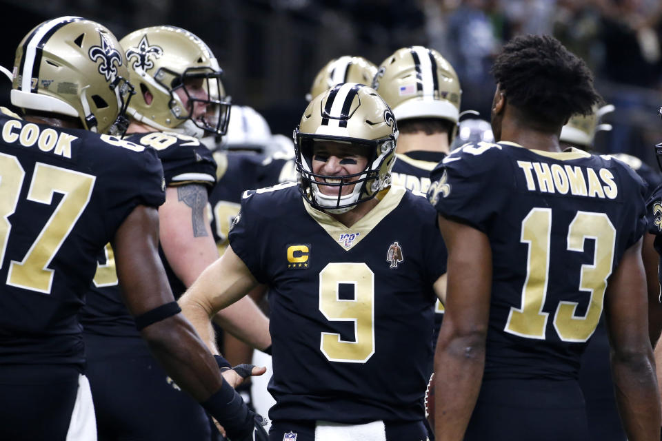 New Orleans Saints quarterback Drew Brees (9) celebrates his touchdown pass to tight end Josh Hill, which broke the NFL record for career touchdown passes. (AP Photo/Butch Dill)