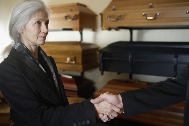 Woman Shaking Hands in Funeral Parlor