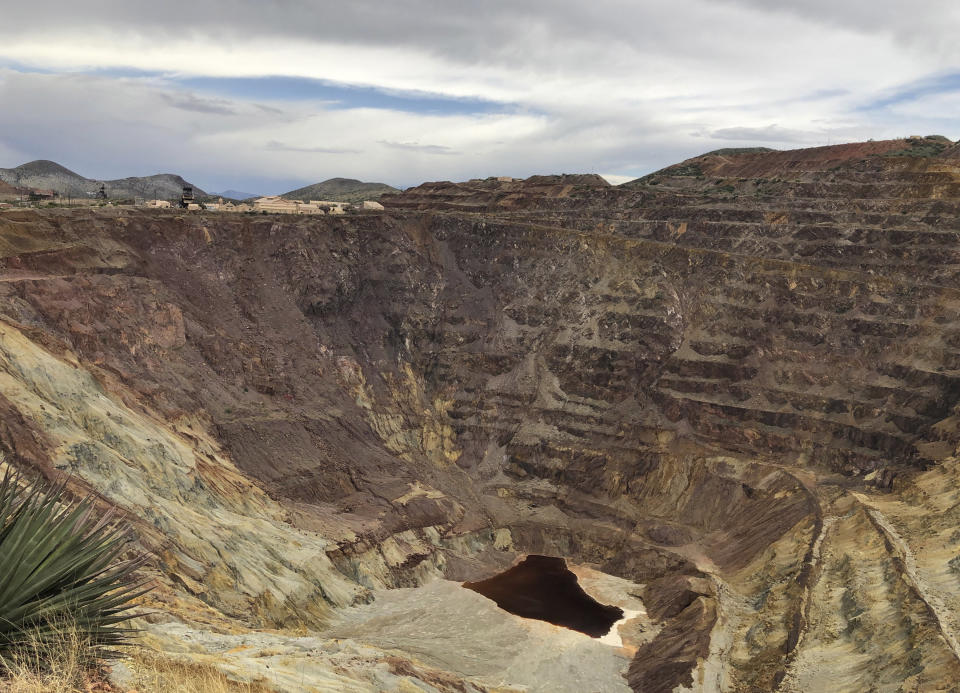 FILE - This, May 12, 2019 file photo, shows what's left of the Lavender pit mine outside the southeastern Arizona city of Bisbee, where the copper operation stopped in 1974. A federal judge on Wednesday, July 31, 2019, has overturned the U.S. Forest Service's approval of a Canadian company's planned new copper mine in southeastern Arizona. The judge ruled the agency improperly evaluated and considered water use issues associated with the Rosemont Mine planned in the Santa Rita Mountains on part of the Coronado National Forest. (AP Photo/Anita Snow, File)