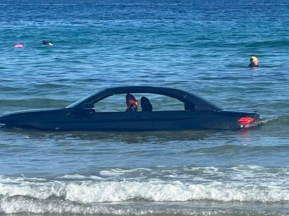 The car partially submerged in the water (St Agnes Coastguard Search & Rescue Team)