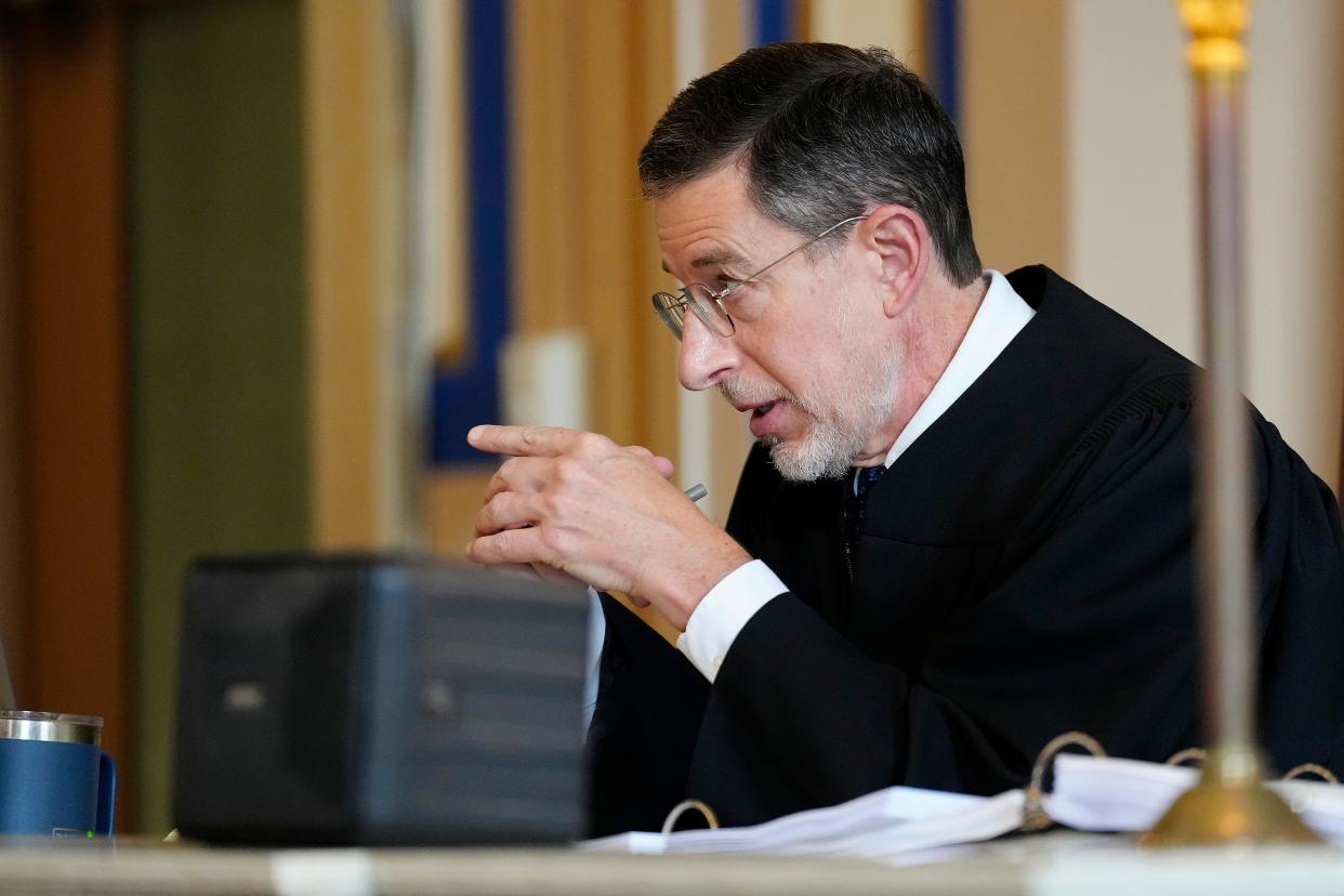 Hamilton County Common Pleas Court Judge Christian Jenkins speaks to Assistant attorney general Amanda Narog in his courtroom in downtown Cincinnati on Friday, Oct. 7, 2022.  Jenkins heard arguments Friday on whether to extend a block on Ohio's law banning virtually all abortions on a more permanent basis. (Sam Greene /The Cincinnati Enquirer via AP) ORG XMIT: OHCIN105