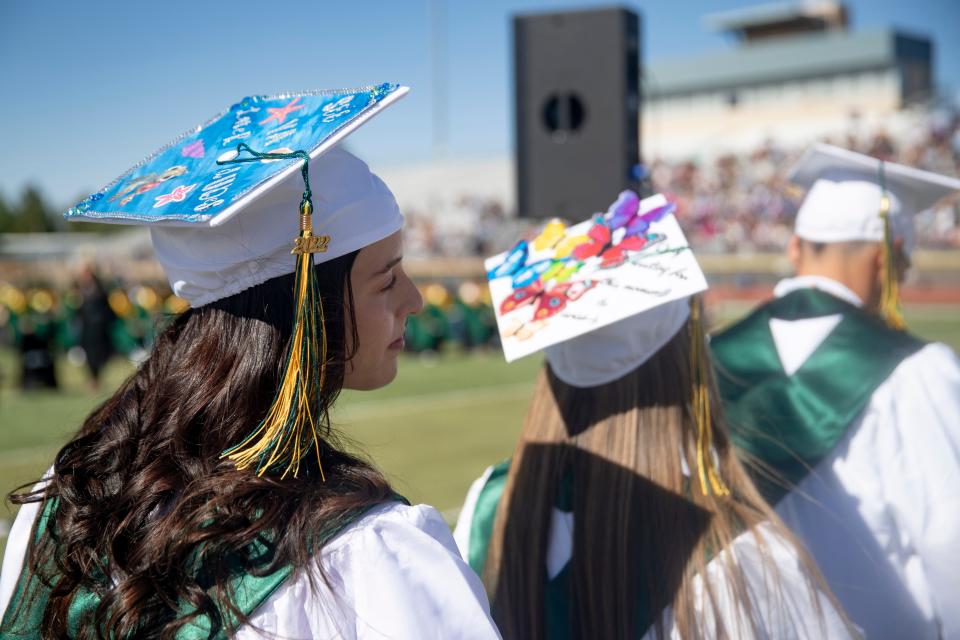 Mayfield High School graduates wait in line for their diplomas during their graduation ceremony at the Field of Dreams on Saturday, May 21, 2022.