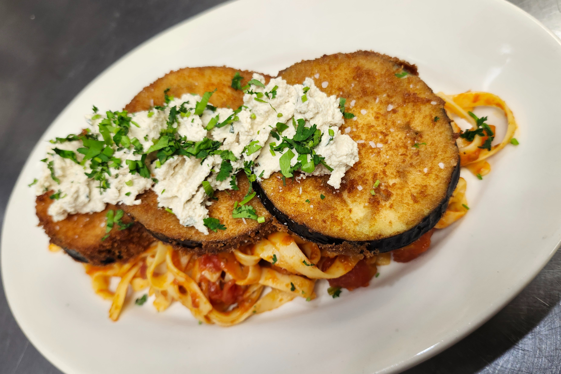 The eggplant Parmesan at Veggeez is served with linguine and tossed with a classic tomato sauce and fresh basil, and includes walnut ricotta.