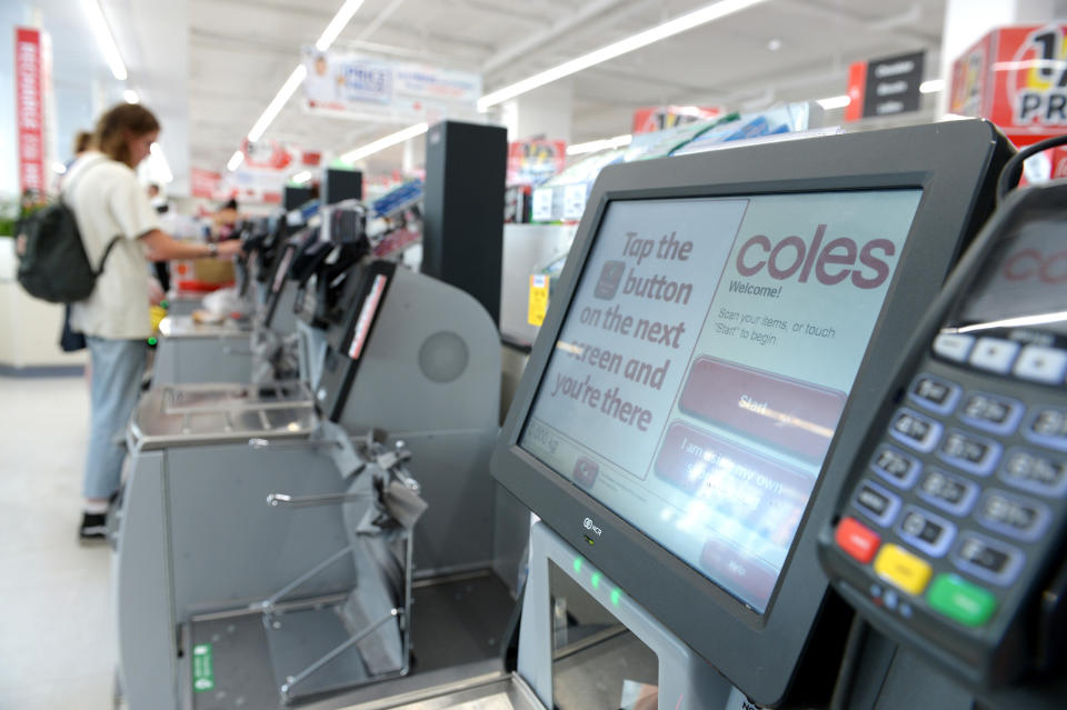 Instructions are displayed on the screen of a self checkout counter in a Coles supermarket.