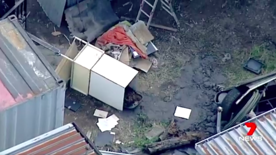 The crate contained a wheelie bin in which a body was covered with grass cuttings. Source: 7 News