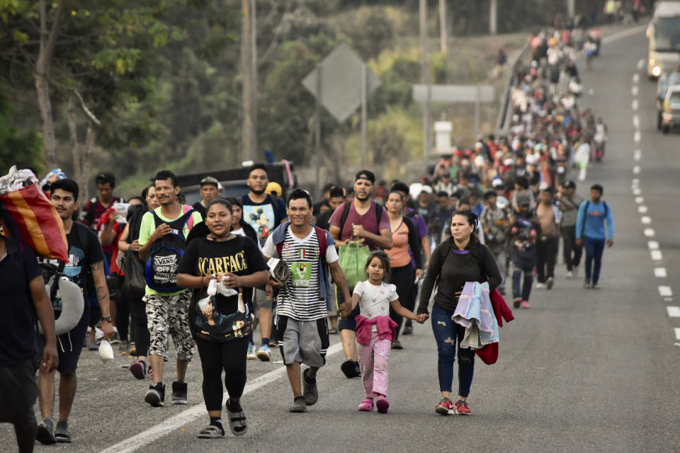 Migrants march to Huehuetan, Chiapas state, Mexico, Monday, April 24, 2023. About 3,000 migrants began walking before dawn for a second day of protest march demanding the end of detention centers like the one that caught fire last month, killing 40 migrants. (AP Photo/Edgar H. Clemente)