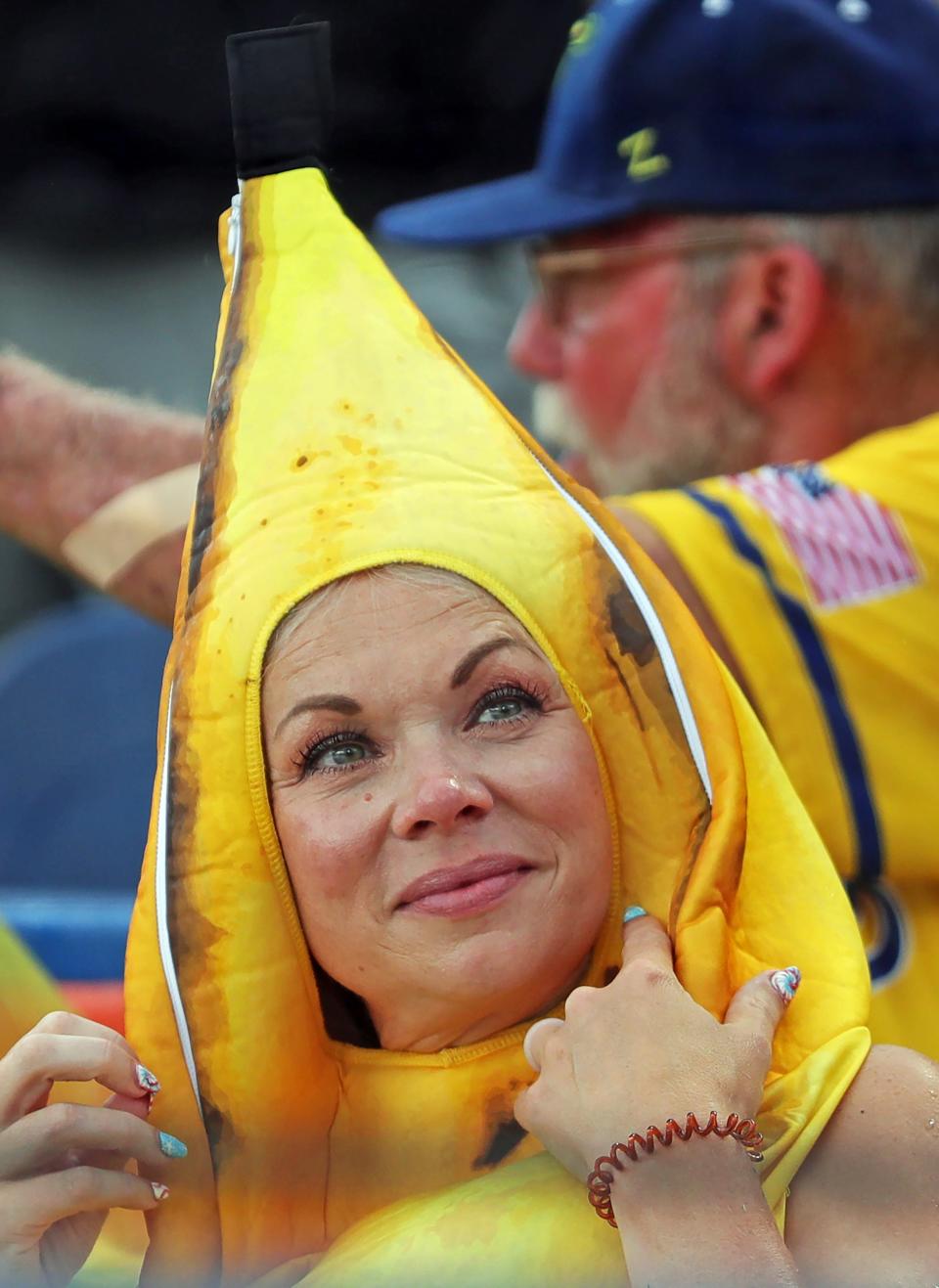 A fan watches the pregame show during the Savannah Bananas' World Tour at Canal Park Monday in Akron.