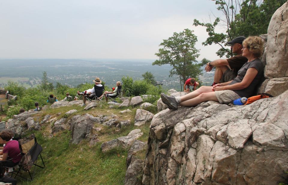 A Wausau couple sits on a rock during a 2011 concert at the Rib Mountain State Park Amphitheater. The Wisconsin Department of Natural Resources is proposing upgrading the facilities at the top of the mountain for more visitors and a variety of events.