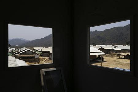 Kyein Ni Pyin camp for internally displaced people is pictured through the windows of an empty building at the camp in Pauk Taw, Rakhine state, April 23, 2014. REUTERS/Minzayar