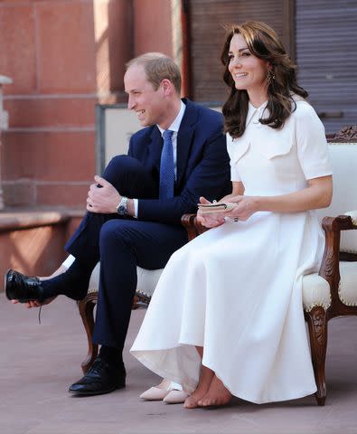 <p>Samir Hussein/Pool/WireImage</p> Prince William and Kate Middleton remove their shoes in India in 2016