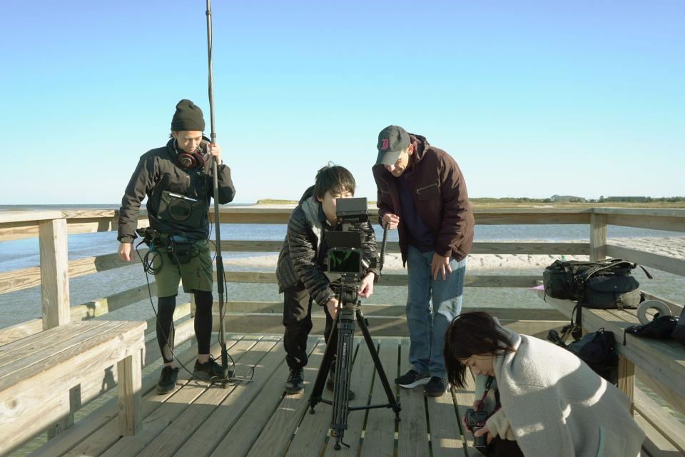 From left, sound designer Ryoma Miki, cameraman Shota Uchiyama, director Steven J Martin and actress Naoki Kondo prepare for a scene for a short film being shot Monday, Oct. 10 at Cahoon Hollow Beach in Truro. The crew from Japan will be on hand for the screening of a different film Saturday as part of a Hyannis Film Festival event.