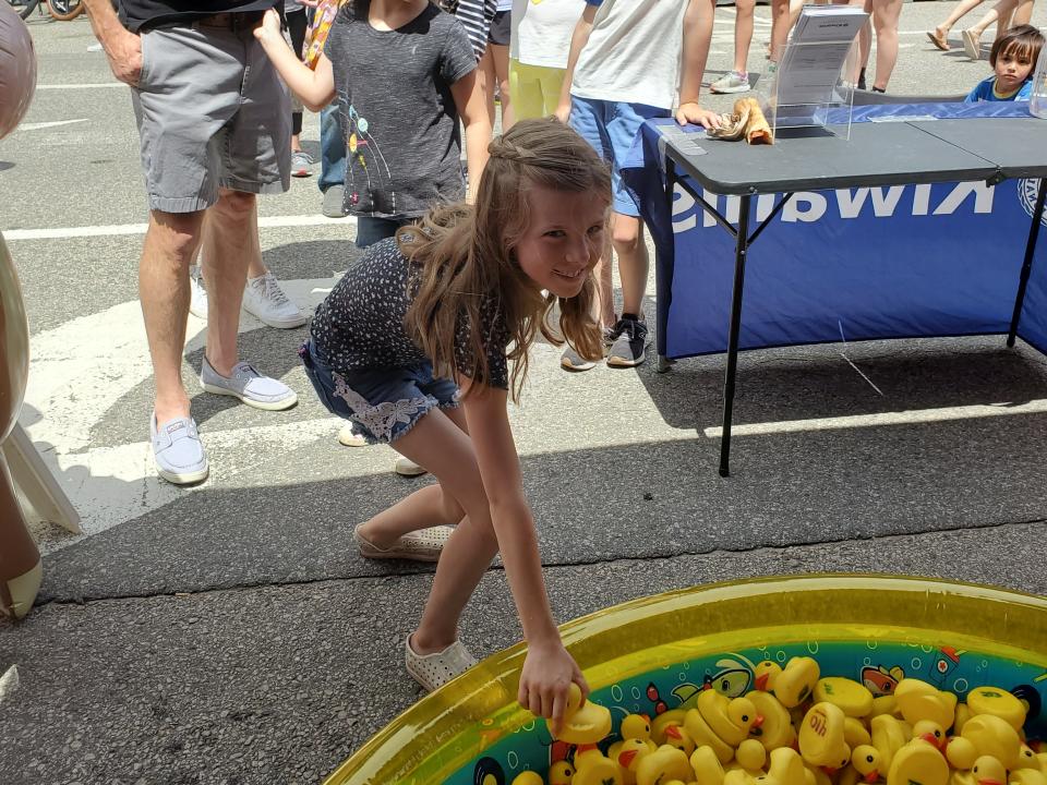 Asla Lynch, 8, chooses a rubber Duck at the Kiwanis booth, to see what prize she will win.