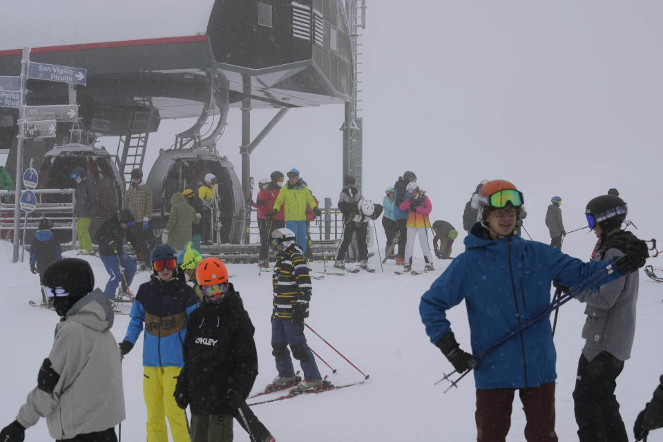 Tourists enjoy skiing, at Plan de Corones ski area, Italy South Tyrol, Saturday, Nov. 27, 2021. After nearly two years of being restricted to watching snow accumulate on distant mountains, Italian skiers are finally returning to the slopes that have been off limits since the first pandemic lockdown in March 2020. But just as the industry is poised to recover from a lost 2020-2021 season after an abrupt closure the previous year, a spike in cases in the Alpine province bordering Austria is underlining just how precarious the situation remains. (AP Photo/Luca Bruno)