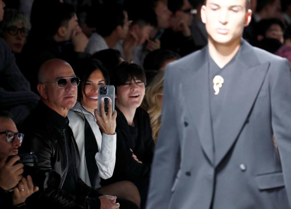 Jeff Bezos and Lauren Sanchez watch her son, Nikko Gonzalez, on the Dolce & Gabbana runway show.