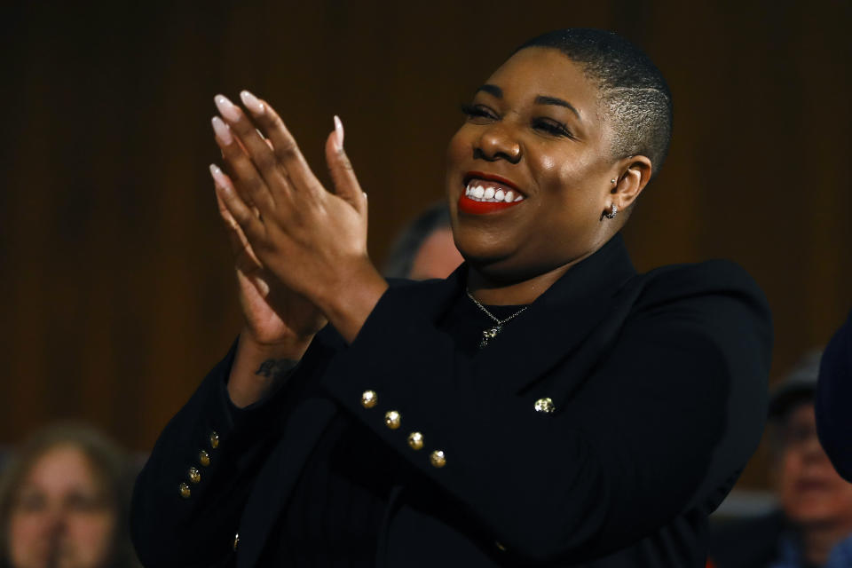 Senior adviser Symone Sanders applauds