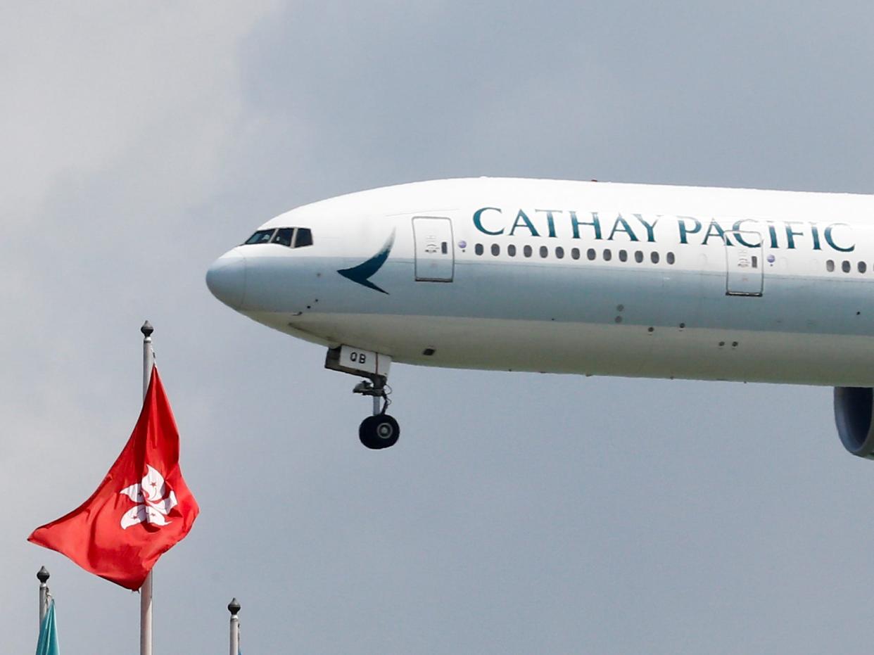 FILE PHOTO: FILE PHOTO: A Cathay Pacific Boeing 777-300ER plane lands at Hong Kong, China August 14, 2019. REUTERS/Thomas Peter