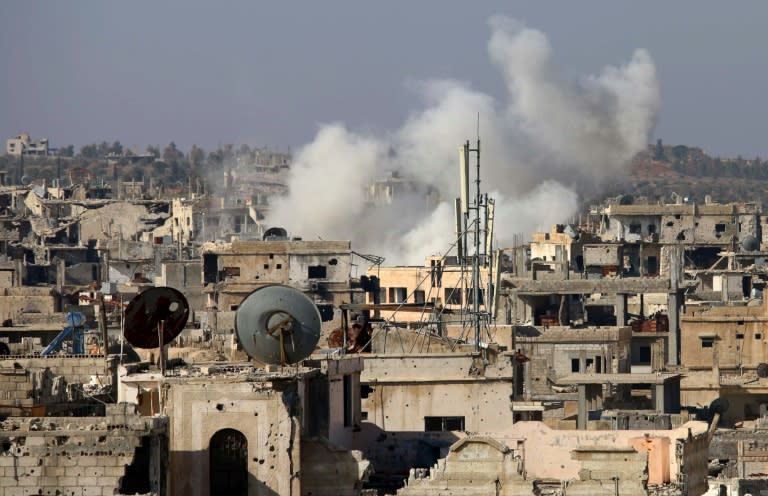 Smoke billows following reported shelling by Syrian government forces in the rebel-held area of Daraa, in southern Syria, on January 18, 2017
