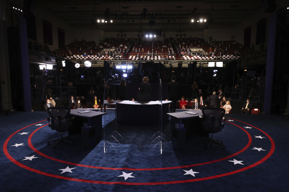 The debate stage is prepared and cleaned for the vice presidential debate between Democratic vice presidential candidate Sen. Kamala Harris, D-Calif., and Vice President Mike Pence at the University of Utah Wednesday, Oct. 7, 2020, in Salt Lake City. (Justin Sullivan/Pool via AP)