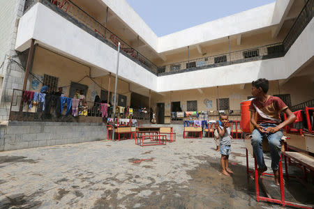 People are pictured at a school to which they have been evacuated from a village near Hodeidah airport amid fighting between government forces and Houthi fighters in Hodeidah, Yemen June 17, 2018. REUTERS/Abduljabbar Zeyad