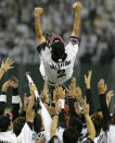 Japan's Chiba Lotte Marines' manager Bobby Valentine (top) of the U.S. is tossed into the air by his teammates after winning the final of the baseball Asia Series 2005 at Tokyo Dome in Tokyo, November 13, 2005. Marines beat Lions 5-3. REUTERS/Toru Hanai