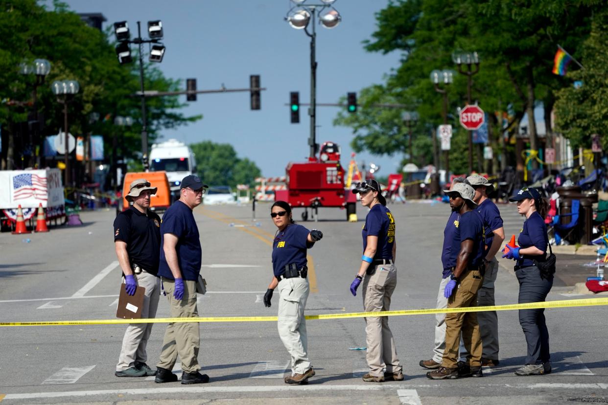 Members of the FBI's evidence response team organize one day after a mass shooting in downtown Highland Park, Ill. Tuesday, July 5, 2022. 