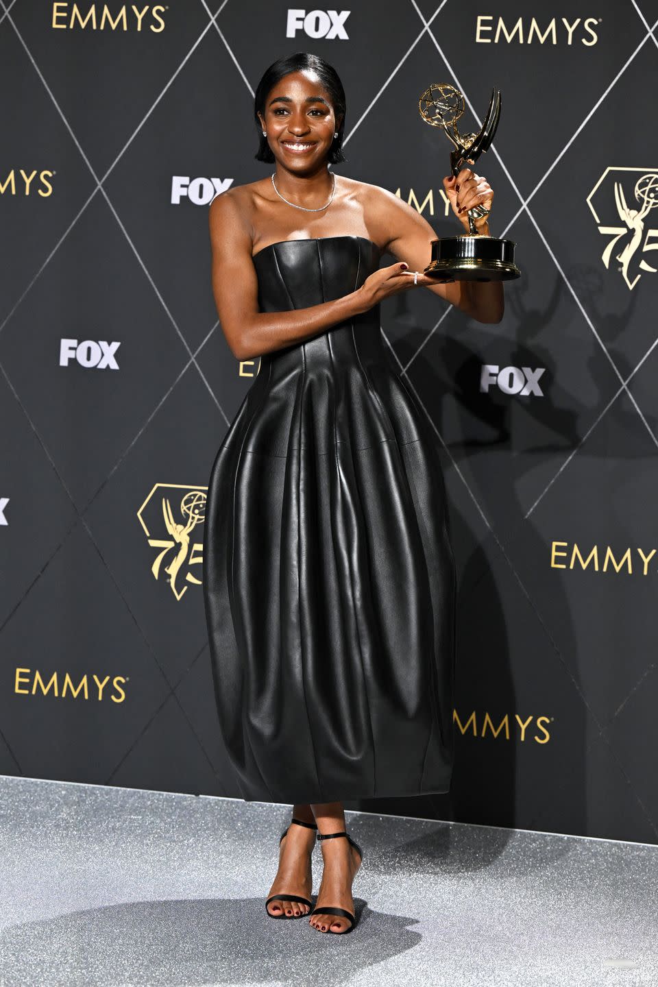 ayo edebiri with her emmy award for best actress