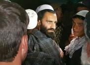 A newly freed Taliban prisoner hugs his relatives outside Bagram prison, north of Kabul