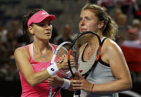 Poland's Agnieszka Radwanska (L) shakes hands with Germany's Anna-Lena Friedsam after Radwanska won their fourth round match at the Australian Open tennis tournament at Melbourne Park, Australia, January 24, 2016. REUTERS/Tyrone Siu