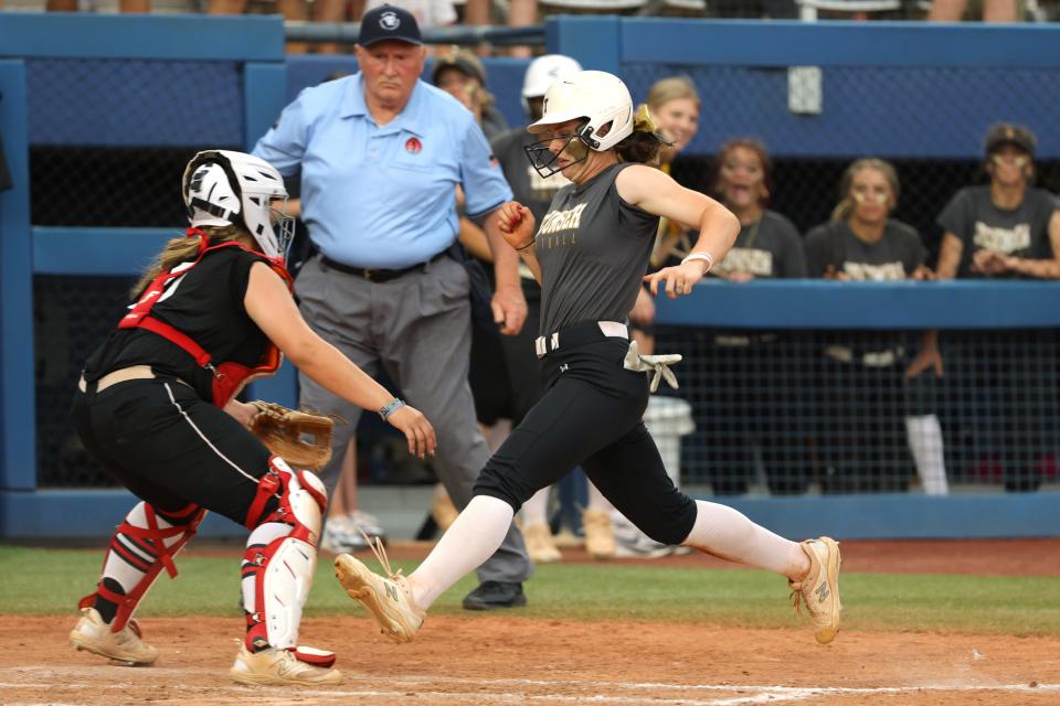 Tecumseh's Katie Overstreet scores a run past Washington's Bailey Hyde during the Class 5A slowpitch softball championship game between Washington and Tecumseh at USA Hall of Fame Stadium in Oklahoma City, Tuesday, April 30, 2024.