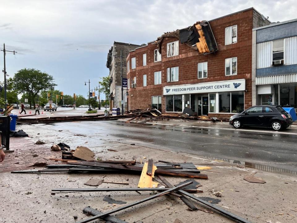 Belleville, Ont., resident Jeanette Arsenault took this picture on Front Street of a roof that blew off another building and onto the Freedom Peer Support Centre across the street Thursday. (Jeanette Arsenault/Twitter - image credit)
