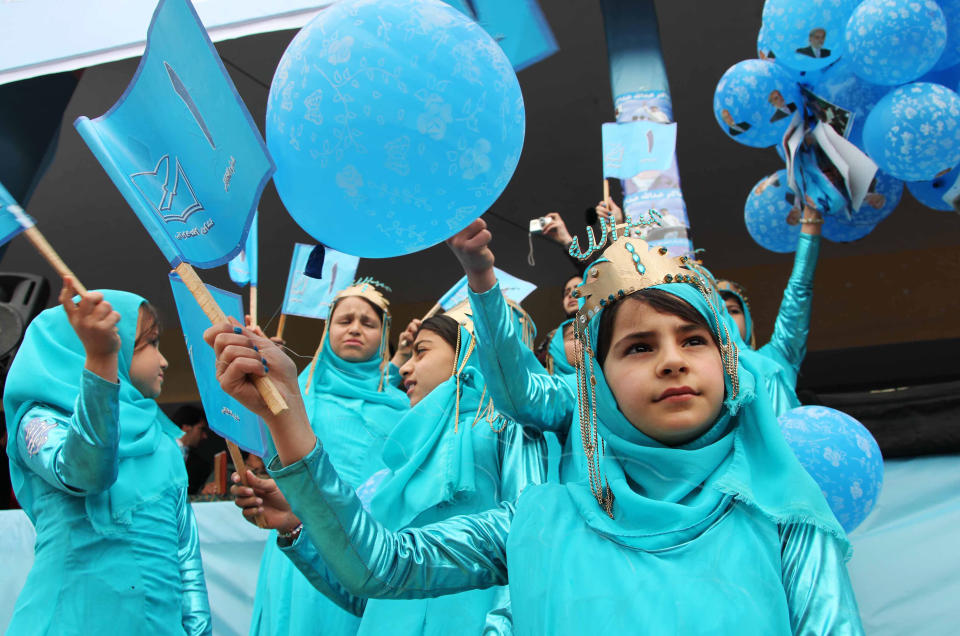 Afghan girls hold flags during a campaign rally for Afghan presidential candidate Abdullah Abdullah in Herat, Afghanistan, Tuesday, April 1, 2014. Writing on the flags reads, "number 1," which refers to Abdullah's number on ballot papers. Eight Afghan presidential candidates are campaigning for the third presidential election. Elections will take place on April 5, 2014. (AP Photo/Hoshang Hashimi)