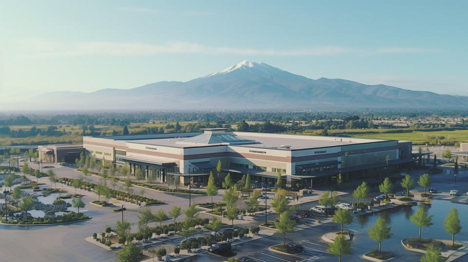 Aerial drone shot of a large shopping center surrounded by stunning West Coast scenery.