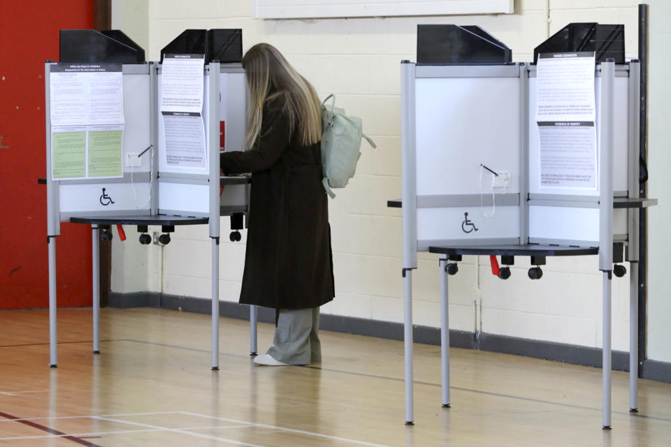 A woman votes in a referendum on the proposed changes to the wording of the Constitution relating to the areas of family and care, at Old St Joseph's Gym Hall, in Dublin, Ireland, Friday, March 8, 2024. As the world marks International Women's Day, in Ireland, voters are deciding on Friday whether to change the constitution to remove passages referring to women’s domestic duties and broadening the definition of the family. (Gareth Chaney/PA via AP)