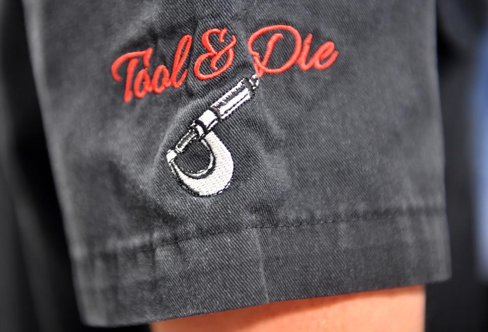 Employees in the tool and die department at PGT Innovations get embroidered work shirts.
