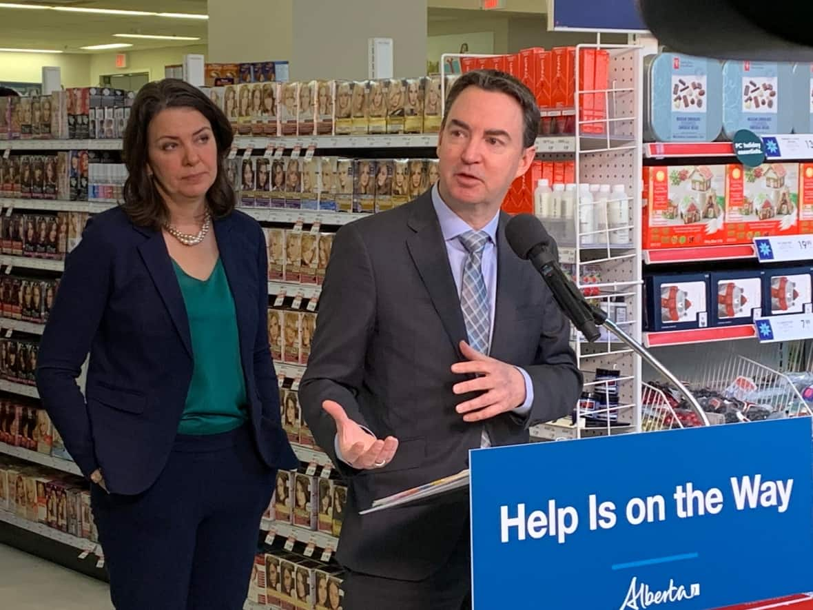 Health Minister Jason Copping, right, answers reporters' questions after Premier Danielle Smith, left, announced Alberta has found a source of children's pain and fever relief medication, which has been in short supply throughout Canada for months. (Dave Bajer/CBC - image credit)