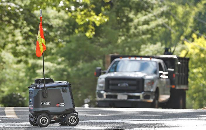 Kiwibot, a&nbsp;semi-autonomous robot, delivers food on the campus of Curry College in Milton.