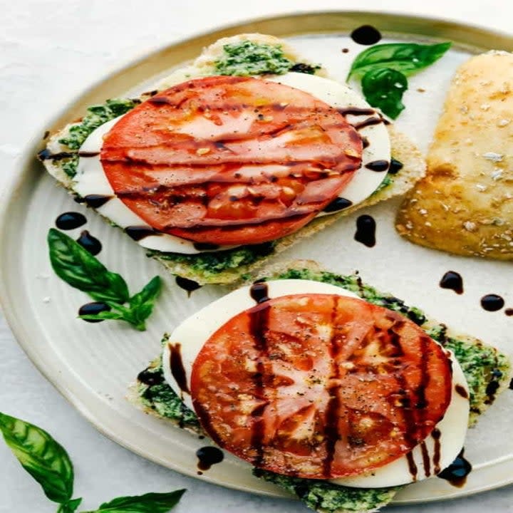 Sandwich bread topped with pesto, mozzarella, tomato, and balsamic.