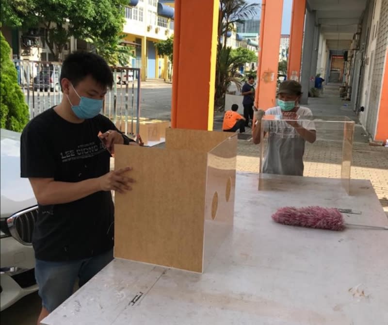 One of Simon Yap’s workers assembling the aerosol boxes which doctors and nurses use as a protective layer. — Picture courtesy of Simon Yap