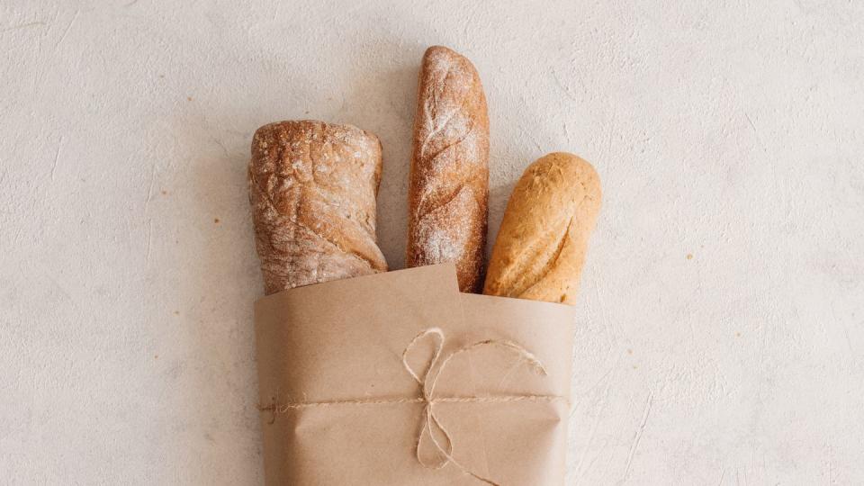 fresh bread on wooden table top view with space for your text