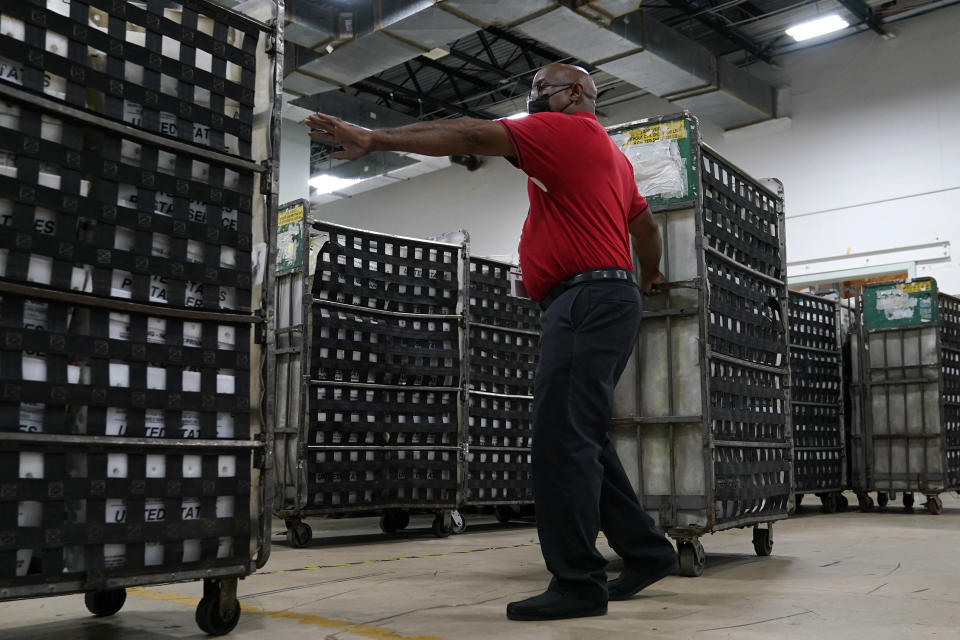 Employees load vote-by-mail ballots into a truck for transport to a local U.S. Postal Service office at the Broward Supervisor of Elections Office, Thursday, Sept. 24, 2020, in Lauderhill, Fla. Florida Democrats are building a substantial lead in mail-in ballot requests for November's presidential election, but questions remain about whether that will be a significant advantage for Joe Biden as he tries to wrest the nation's largest swing state from President Donald Trump. (AP Photo/Lynne Sladky)