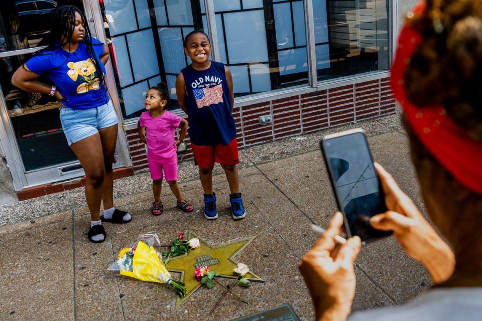 Barbara Martin, 72, of Kingsway West, snaps a photo of her grandchildren Miah McCellary, 16, Phynx Laurel, 2, and Rataka Marshall, 7, in front of Tina Turner’s star on the St. Louis Walk of Fame after her passing on Wednesday, May 24, 2023, on the Delmar Loop in University City. “Tina Turner’s death was a real shocker,” Martin said. “We’re really just losing all of our greats. Wow, just wow.”